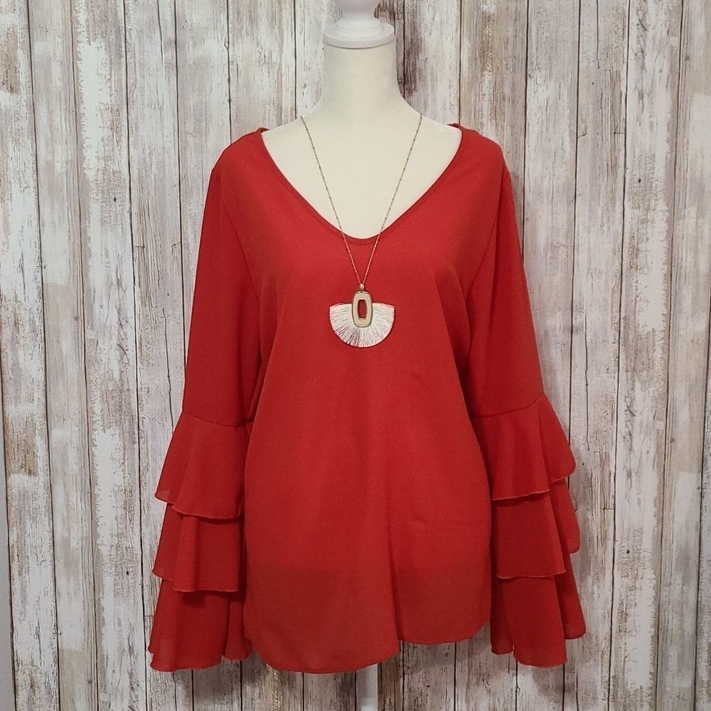 Women's rust red bell sleeve blouse.